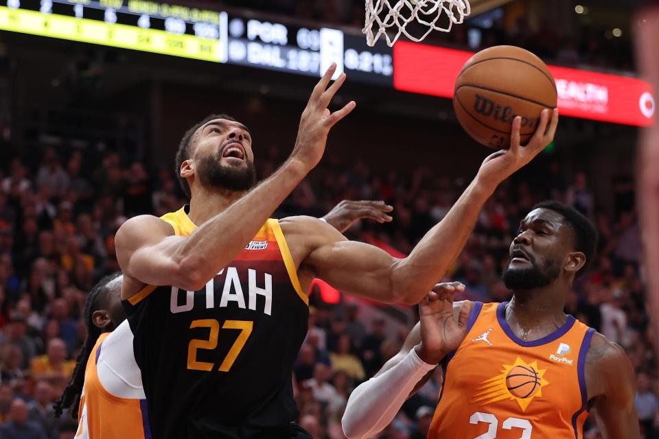 Apr 8, 2022; Salt Lake City, Utah, USA; Utah Jazz center Rudy Gobert (27) attempts a layup in front of Phoenix Suns center Deandre Ayton (22) in the second quarter at Vivint Arena.