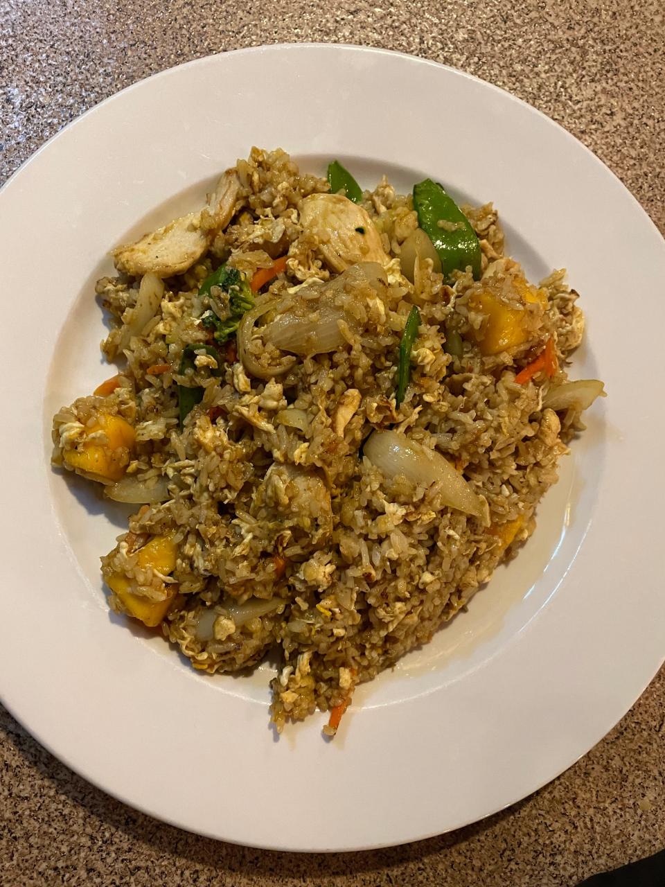 The mango fried rice has mango, chicken and egg plus mixed vegetables all stir-fried with a yellow powder.