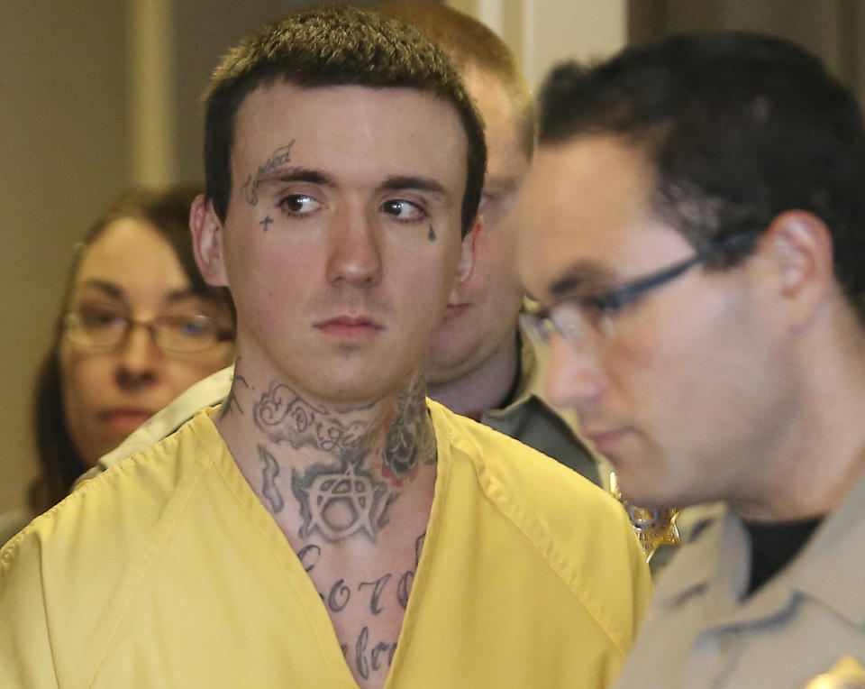 Austin Boutain is lead in to the courtroom during a hearing Wednesday, Sept. 12, 2018, in Salt Lake City. Boutain, an ex-convict charged with gunning down a University of Utah student from China using a stolen gun from a previous killing, pleaded guilty to murder and kidnapping charges. Boutain entered the pleas in an agreement with prosecutors that allows him to avoid a possible death penalty. He was sentenced to life without parole. (AP Photo/Rick Bowmer, Pool)