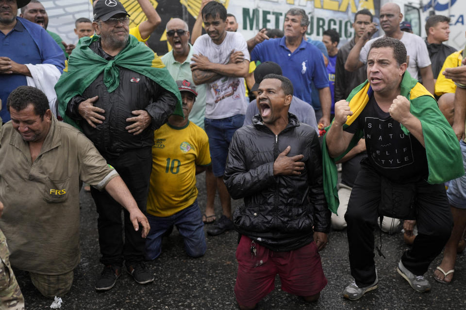 Truckers supportive of President Jair Bolsonaro block a highway to protest his run-off election loss to former President Luiz Inacio Lula da Silva in Itaborai, Rio de Janerio state, Brazil, Tuesday, Nov. 1, 2022. (AP Photo/Silvia Izquierdo)