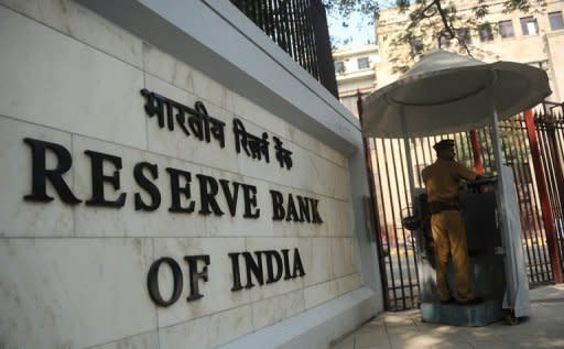 A policeman stands guard outside India's central bank, the Reserve Bank of India, in Mumbai. The bank cut its main interest rates by 50 basis points on Tuesday -- its first reduction in three years -- but said there was limited scope for further easing