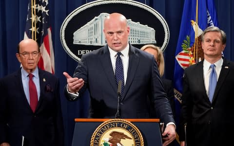 Acting Attorney General Matthew Whitaker speaks flanked by U.S. Commerce Secretary Wilbur Ross (L) and FBI Director Christopher Wray (R) during a news conference to announce indictments against China's Huawei Technologies  - Credit: Reuters