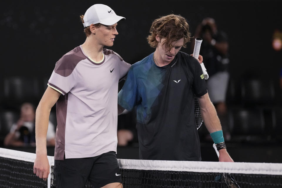 Jannik Sinner, left, of Italy is congratulated by Andrey Rublev of Russia following their quarterfinal match at the Australian Open tennis championships at Melbourne Park, Melbourne, Australia, Wednesday, Jan. 24, 2024. (AP Photo/Alessandra Tarantino)