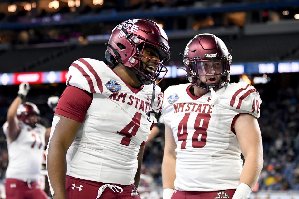 Dec 26, 2022; Detroit, Michigan, USA; New Mexico State running back Star Thomas (4) (center) runs for a touchdown after catching a short pass against Bowling Green in the first quarter in the 2022 Quick Lane Bowl at Ford Field.