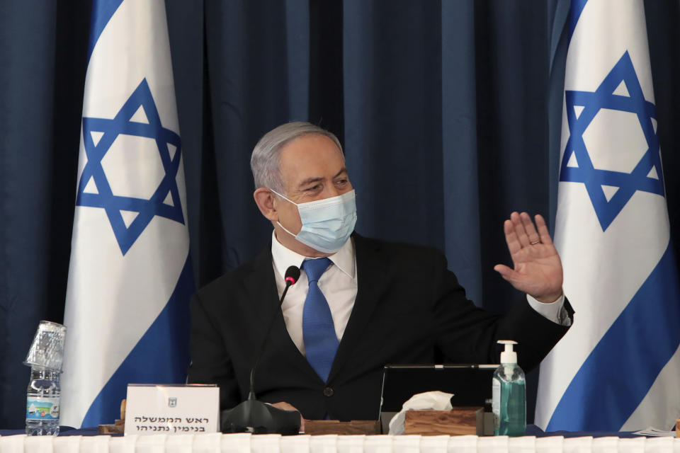 Israeli Prime Minister Benjamin Netanyahu wears a face mask to help prevent the spread of the coronavirus as he chairs the weekly cabinet meeting, at the foreign ministry, in Jerusalem, Sunday, July 5, 2020. (Photo by Gali Tibbon/Pool via AP)