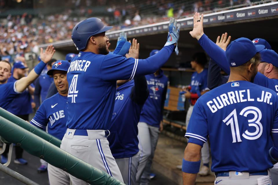 George Springer of the Toronto Blue Jays celebrates scoring a run in the first inning with teammates while playing the Detroit Tigers on Friday, June 10, 2022, at Comerica Park in Detroit.