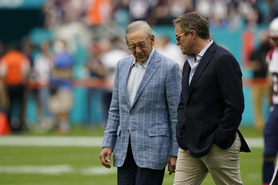 Stephen Ross talks with Tom Garfinkel on the field during warm-ups.