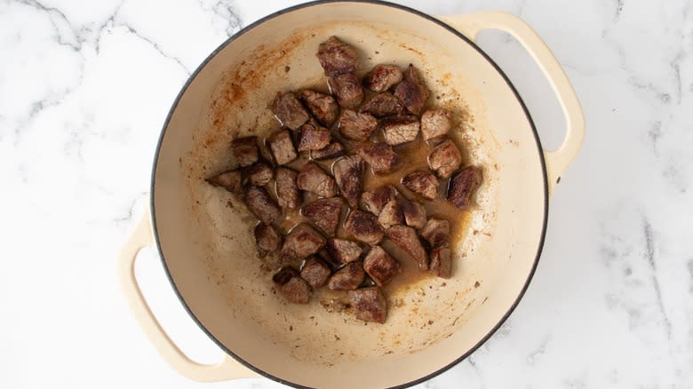 beef chunks searing in dutch oven