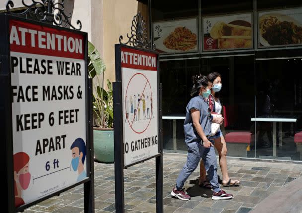 PHOTO: Customers wear face masks in an outdoor mall with closed business amid the COVID-19 pandemic in Los Angeles, June 11, 2021. (Damian Dovarganes/AP, FILE)