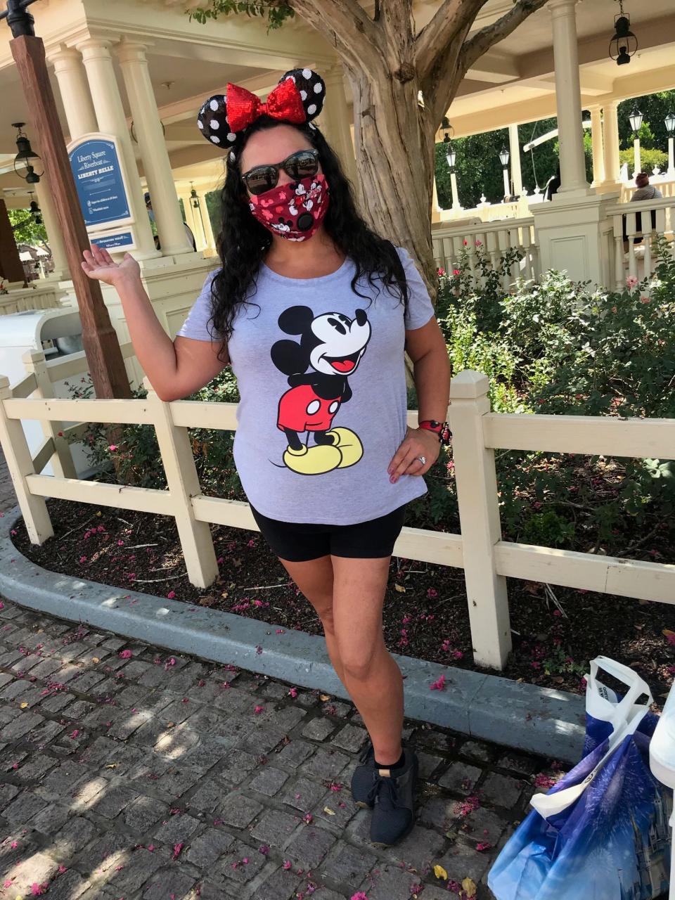 Karen Fernandez of Happy Trails, Florida, takes a break during a preview for annual passholders at Walt Disney World’s Magic Kingdom, which reopens Saturday.