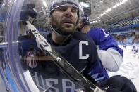 <p>Brian Gionta, left, of the United States, is checked by Tomas Starosta, of Slovakia, during the third period of the qualification round of the men’s hockey game at the 2018 Winter Olympics in Gangneung, South Korea, Tuesday, Feb. 20, 2018. (AP Photo/Julio Cortez) </p>