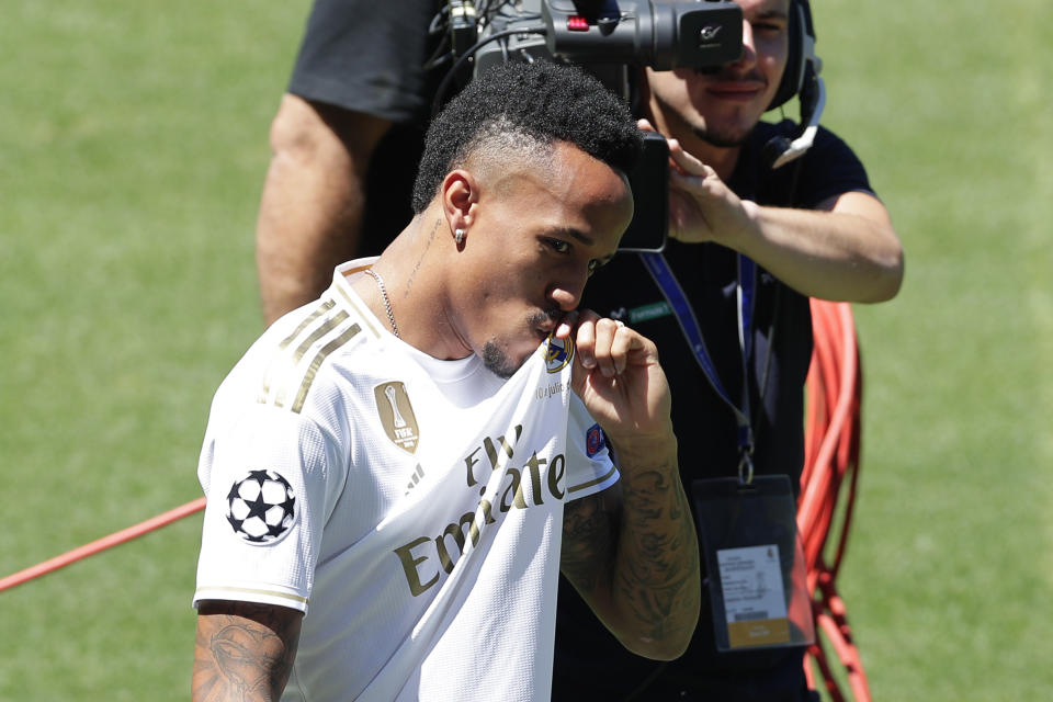 Eder Militao kisses his shirt during his official presentation after signing for Real Madrid at the Santiago Bernabeu stadium in Madrid, Spain, Wednesday, July 10, 2019. (AP Photo/Manu Fernandez)