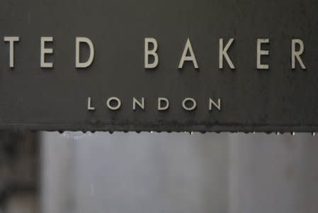 Rain drips off a sign on a Ted Baker sign on a store in London, Britain October 06, 2015.  REUTERS/Neil Hall - LR1EBA612FS1K