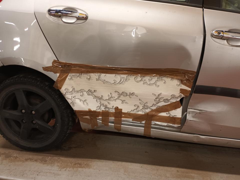 The Silver Toyota Yaris with wallpaper used to plug a hole in the bodywork. Photo released February 5 2024. See SWNS story SWMRpaper. A driver has been pulled over by police after fixing his smashed-up car – with wallpaper.Hilarious photos show how the motorist had used parcel tape and the flower-themed lining to hide a huge hole in the bodywork of his Silver Toyota Yaris hatchback.Stunned officers who spotted the baffling bodge job while checking vehicles in Bradford, West Yorks, called the car the “highlight of the evening”.They said the motor had previously been banned from driving by the Driving Standards Agency - and added that its owner was reported for its terrible condition.
