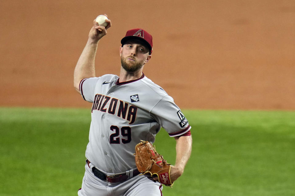 Arizona Diamondbacks starting pitcher Merrill Kelly throws against the Texas Rangers during the first inning in Game 2 of the baseball World Series Saturday, Oct. 28, 2023, in Arlington, Texas. (AP Photo/Julio Cortez)