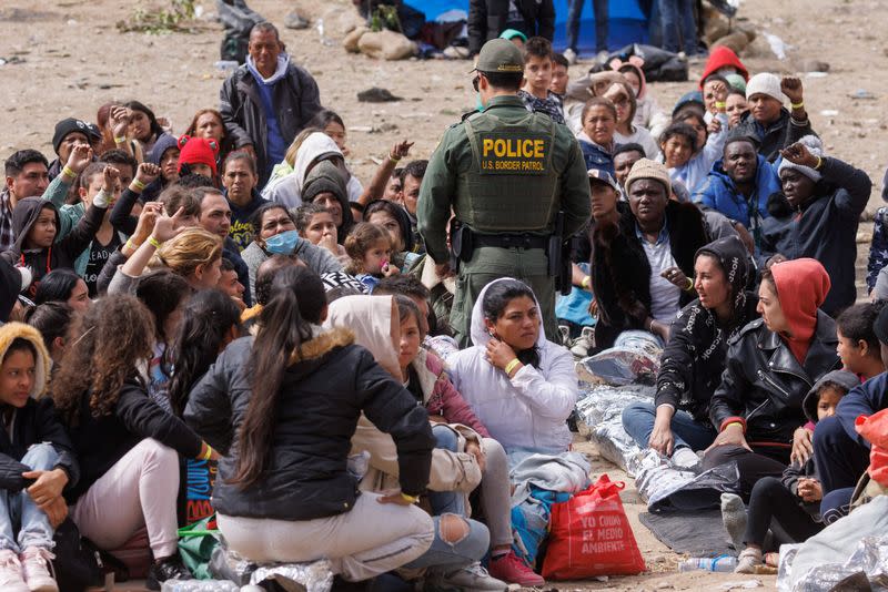 Migrants gather along the U.S. Mexico border near San Diego before the lifting of Tile 42