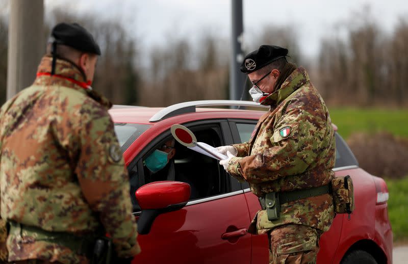 FILE PHOTO: Members of the Italian army guard the entrance of the red zone of Turano Lodigiano