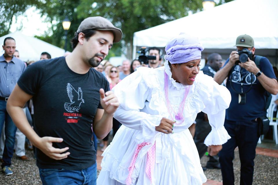 Lin-Manuel Miranda dances with Grupo Cimiento de Puerto Rico during Fiesta del Pueblo at Vega Alta Plaza on Tuesday in Vega Alta, Puerto Rico.