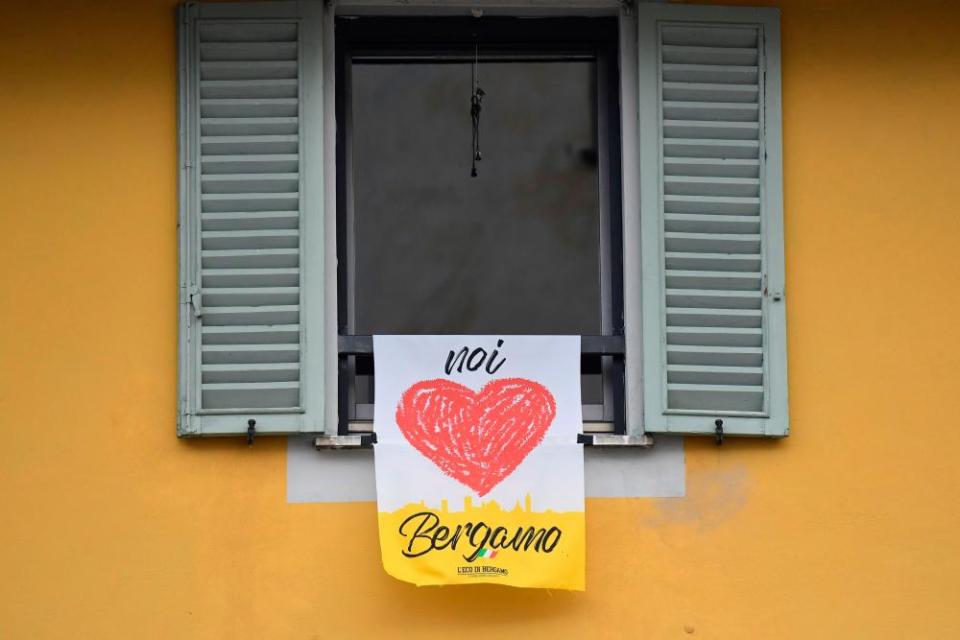 A banner reading ‘We love Bergamo’ hangs at a window in the upper part of the city.