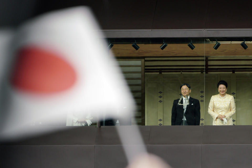 Japan's Emperor Naruhito stands with Empress Masako to well-wishers from the bullet-proofed balcony during their public appearance with his imperial families at Imperial Palace in Tokyo Thursday, Jan. 2, 2020. (AP Photo/Eugene Hoshiko)