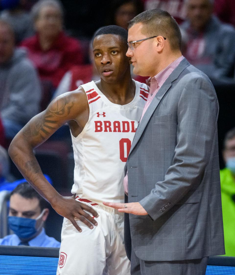 Bradley head coach Brian Wardle talks with junior guard Terry Roberts late in the second half of their game against SIU-Edwardsville on Saturday, Dec. 4, 2021 at Carver Arena. The Braves defeated the Cougars 80-55. Roberts led the Braves with 17 points.