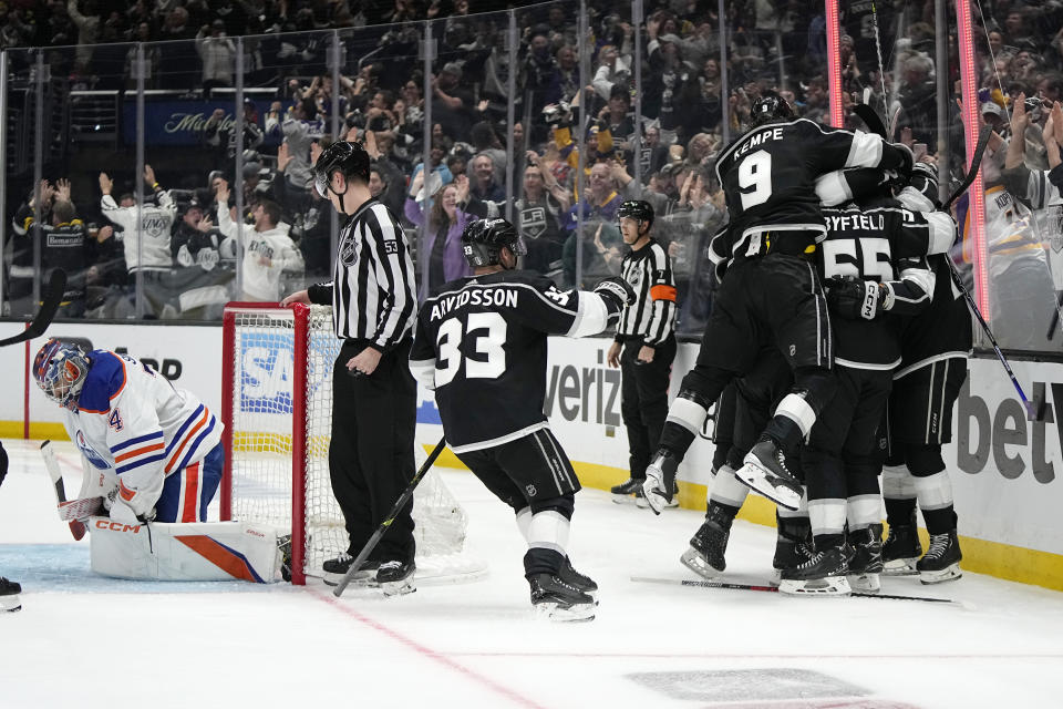 Members of the Los Angeles Kings celebrates a game-winning goal by left wing Trevor Moore as Edmonton Oilers goaltender Stuart Skinner, left, sits in goal during the overtime in Game 3 of an NHL hockey Stanley Cup first-round playoff series Friday, April 21, 2023, in Los Angeles. The Kings won 3-2. (AP Photo/Mark J. Terrill)