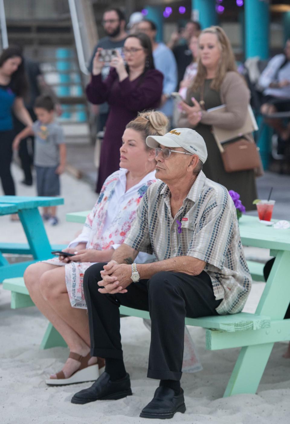 Andy Carli, right, listens during a candlelight vigil in honor of his daughter Cassie Carli at Windjammers on the Pier in Navarre Beach on Thursday, Feb. 23, 2023. Dr. Joel Rudman, Florida House of representative for District 3, announced filing a bill dubbed the "Cassie Carli Law" to establish safe zones for custody exchange of children.