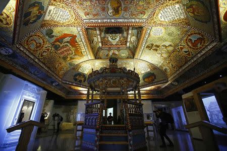 Visitors stand under the "Celestial Canopy", a reconstructed painted ceiling of a synagogue that once stood in Gwozdziec (present-day Ukraine), at the POLIN Museum of the History of Polish Jews in Warsaw October 21, 2014, one week before the official opening of the core exhibition. REUTERS/Kacper Pempel