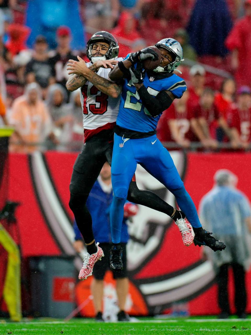Dec 3, 2023; Tampa, Florida, USA; Carolina Panthers safety Xavier Woods (25) intercepts the ball from Tampa Bay Buccaneers wide receiver Mike Evans (13) in the second quarter at Raymond James Stadium. Mandatory Credit: Nathan Ray Seebeck-USA TODAY Sports