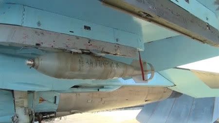 A bomb with the words "For Paris" is seen on a Russian military jet at the Hmeymim air base near Latakia, Syria, in this still image taken from video footage, released by Russia's Defence Ministry on November 20, 2015. REUTERS/Ministry of Defence of the Russian Federation/Handout via Reuters