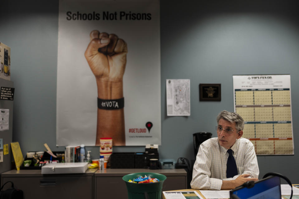 CORRECTS TO ZUCKERMAN, NOT ZUCHERMAN - David Zuckerman, the interim director of the Transforming Outcomes Project at Sacramento State (TOPSS), talks to a formerly incarcerated employee in the school's Project Rebound office in Sacramento, Calif., Wednesday, May 24, 2023. If a prisoner paroles with a degree, never reoffends, gets a job earning a good salary and pays taxes, then the expansion of prison education shouldn’t be a hard sell, says Zuckerman. (AP Photo/Jae C. Hong)