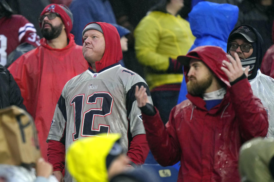 New England Patriots fans look at the scoreboard while trailing the Los Angeles Chargers 0-6 late in the second half of an NFL football game, Sunday, Dec. 3, 2023, in Foxborough, Mass. (AP Photo/Steven Senne)