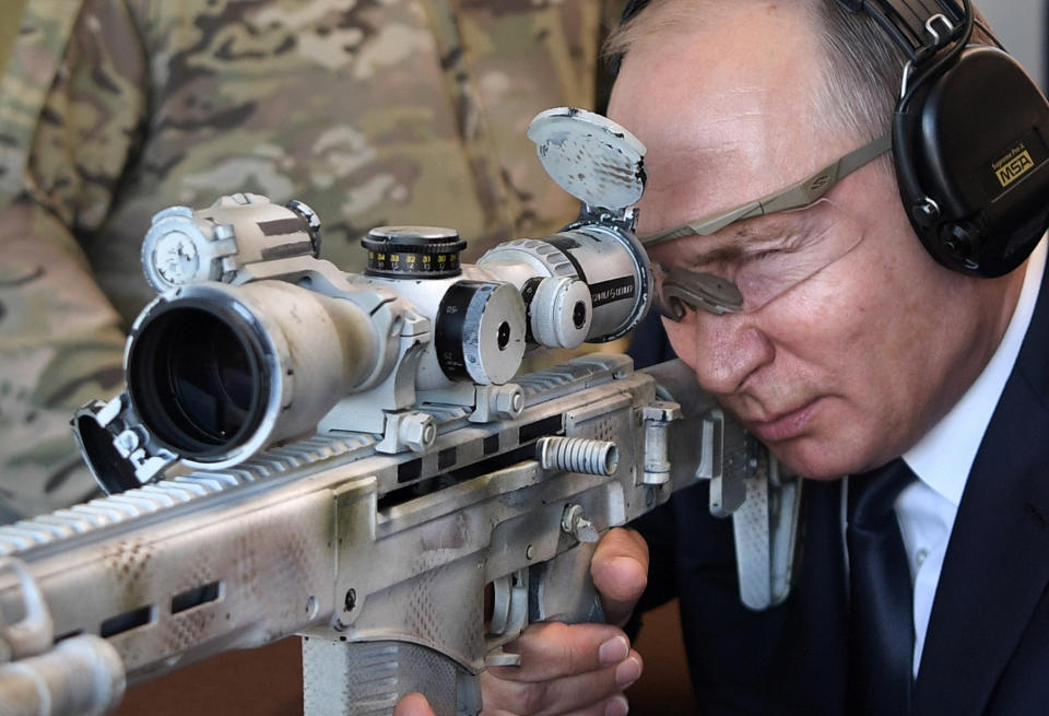 Russian President Vladimir Putin aims a sniper rifle during a visit to the Patriot military exhibition center outside Moscow, Russia, Wednesday, Sept. 19, 2018. Putin chaired a meeting that focused on new arms programs. (Alexei Nikolsky, Sputnik, Kremlin Pool Photo via AP)