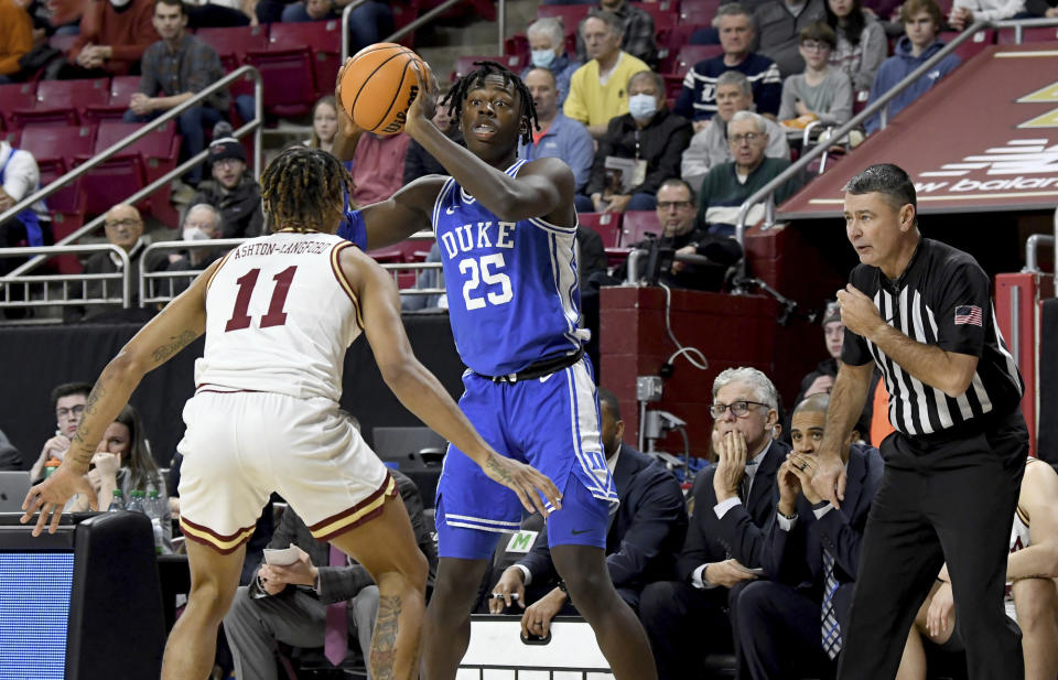 Duke's Mark Mitchell (25) looks for an open teammate as Boston College's Makai Ashton-Langford (11) defends during the first half of an NCAA college basketball game, Saturday, Jan. 7, 2023, in Boston. (AP Photo/Mark Stockwell)