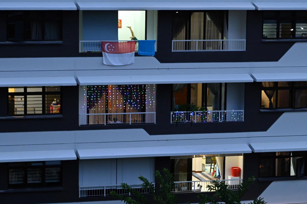 A Singapore flag is seen on the balcony of a flat in Singapore on 23 May, 2020. (PHOTO: AFP via Getty Images)