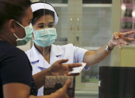 A nurse and a woman wear masks to prevent contracting Middle East Respiratory Syndrome (MERS) at the Bamrasnaradura Infectious Diseases Institute in Nonthaburi province, on the outskirts of Bangkok, Thailand, June 19, 2015. REUTERS/Chaiwat Subprasom
