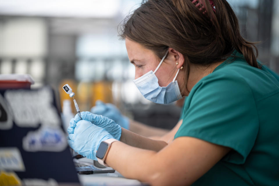 Nurses fill syringes of Pfizer COVID-19 vaccines during a pop-up vaccination event at Lynn Family Stadium  on April 26, 2021 in Louisville, Kentucky. (Jon Cherry/Getty Images)