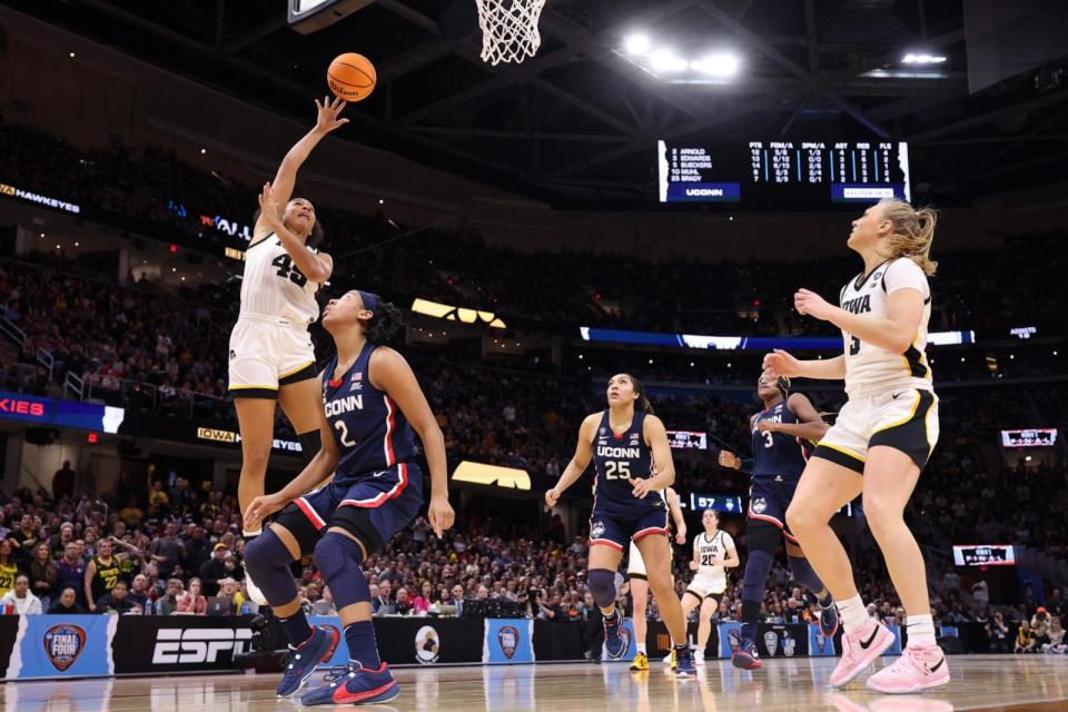 PHOTO: Hannah Stuelke #45 of the Iowa Hawkeyes shoots the ball over KK Arnold #2 of the UConn Huskies during the NCAA Women's Basketball Tournament Final Four semifinal game in Cleveland, OH, April 05, 2024. (Gregory Shamus/Getty Images)
