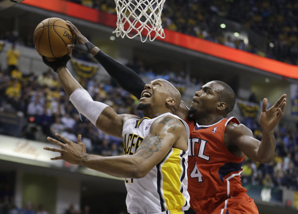 Indiana Pacers' David West (21) has his shot blocked by Atlanta Hawks' Paul Millsap (4) during the second half in Game 5 of an opening-round NBA basketball playoff series Monday, April 28, 2014, in Indianapolis. Atlanta defeated Indiana 107-97. (AP Photo/Darron Cummings)
