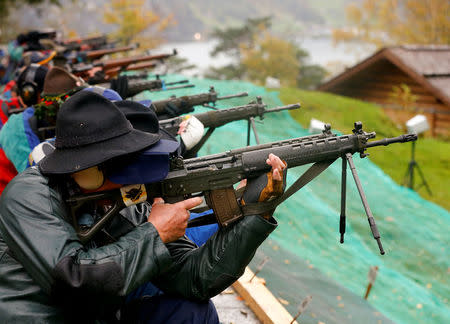 Participants fire their infantry and assault rifles during the traditional 'Ruetlischiessen' (Ruetli shooting) competition at the Ruetli meadow in central Switzerland November 6, 2013. REUTERS/Arnd Wiegmann/File Photo