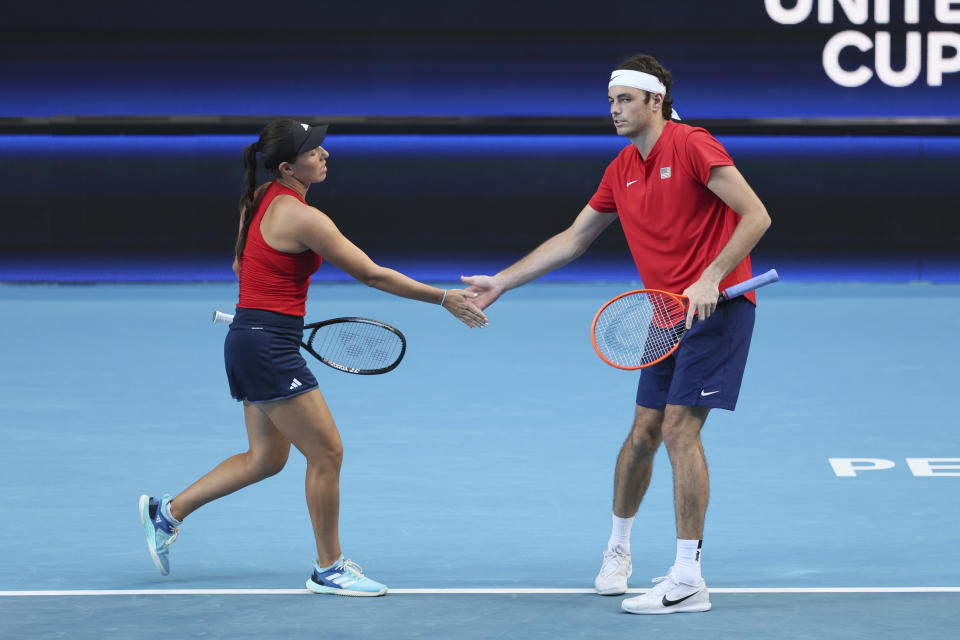 Taylor Fritz of the United States slaps hands with partner Jessica Pegula during their mixed doubles match against Cameron Norrie and Katie Boulter of Britain at the United Cup tennis tournament in Perth, Australia, Sunday, Dec. 31, 2023. (AP Photo/Trevor Collens)