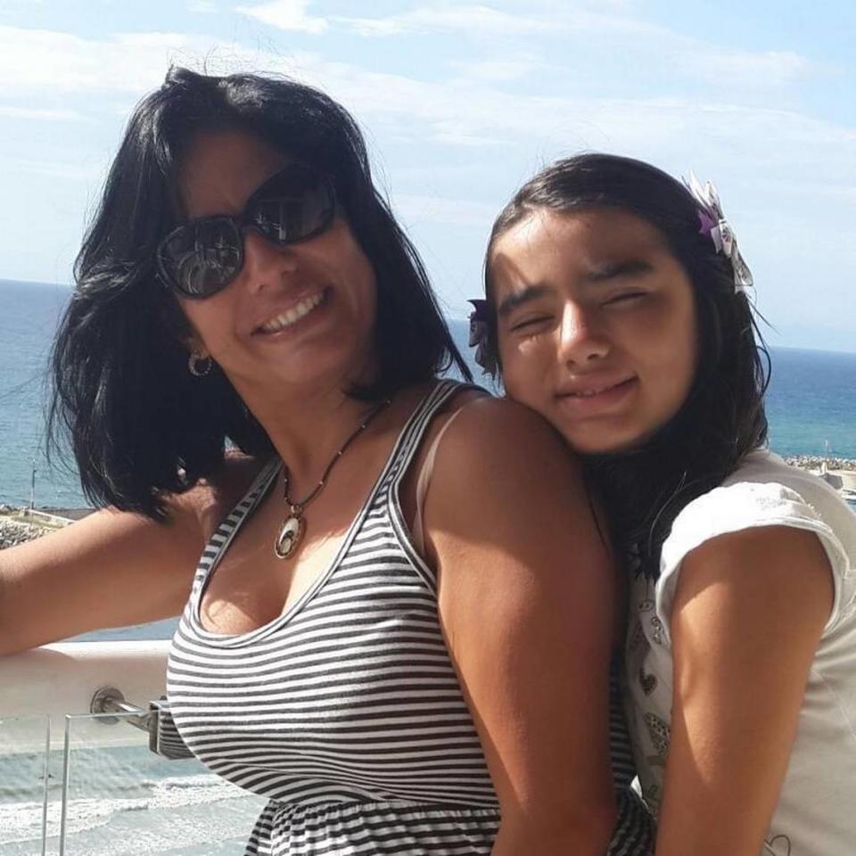 Tamara Mendoza (left) and her daughter, Marielena D’Freites, smile in this photo from 2013. Mendoza was living in North Texas more recently to send money back home to her daughter, who is now 18.