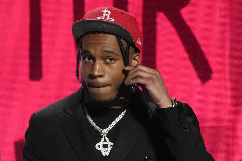 Cam Whitmore adjusts his hair on stage after being selected 20th overall by the Houston Rockets during the NBA basketball draft, Thursday, June 22, 2023, in New York. (AP Photo/John Minchillo)