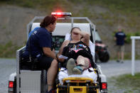 <p>A woman is taken for treatment after she collapsed at the Remote Area Medical Clinic in Wise, Va., July 21, 2017. (Photo: Joshua Roberts/Reuters) </p>