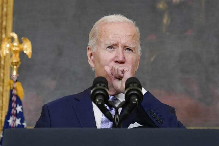 FILE - President Joe Biden coughs as he speaks about "The Inflation Reduction Act of 2022" in the State Dining Room of the White House in Washington, Thursday, July 28, 2022. Biden tested positive for COVID-19 again Saturday, July 30, slightly more than three days after he was cleared to exit coronavirus isolation, the White House said, in a rare case of "rebound" following treatment with an anti-viral drug. (AP Photo/Susan Walsh, File)