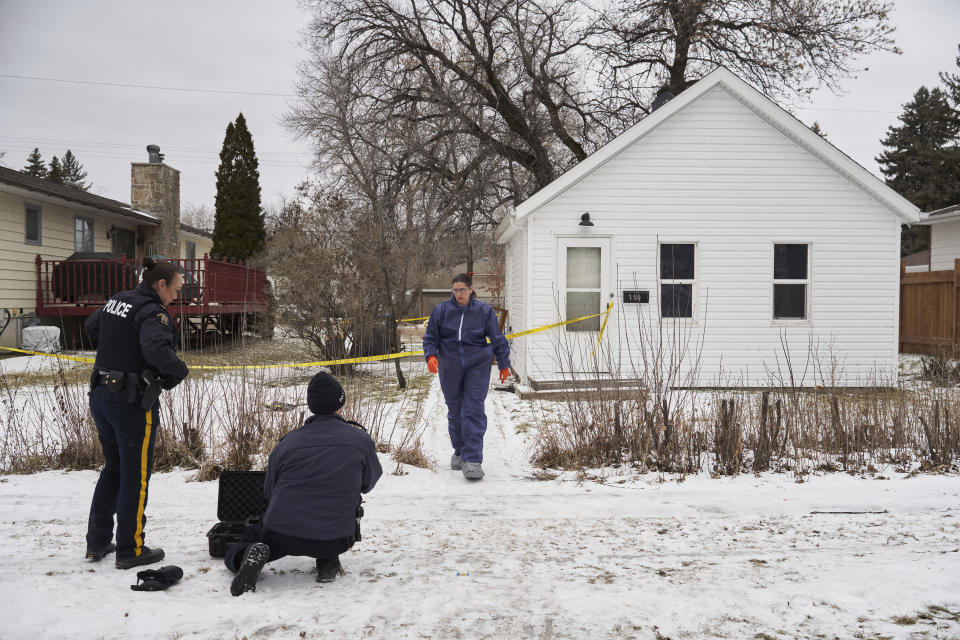 Royal Canadian Mounted Police and forensic investigators work on the scene of an ongoing investigation regarding five deaths in southern Manitoba, in Carman, Manitoba, Monday, Feb. 12, 2024. A Canadian man has been charged with five counts of first-degree murder in the deaths of his wife, three young children and a 17-year-old female relative, authorities said Monday. (David Lipnowski/The Canadian Press via AP)