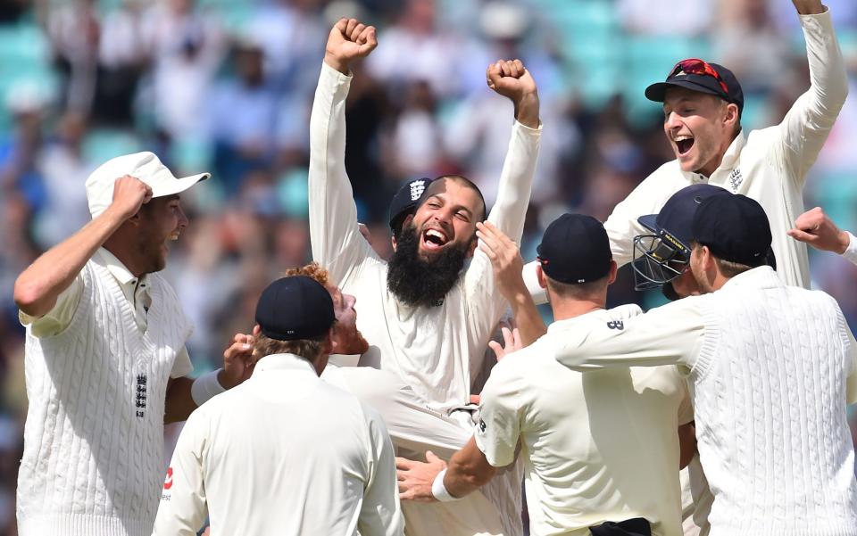 Moeen Ali celebrating with his team-mates - Moeen Ali persuaded to come out of retirement for The Ashes - AFP/GLYN KIRK
