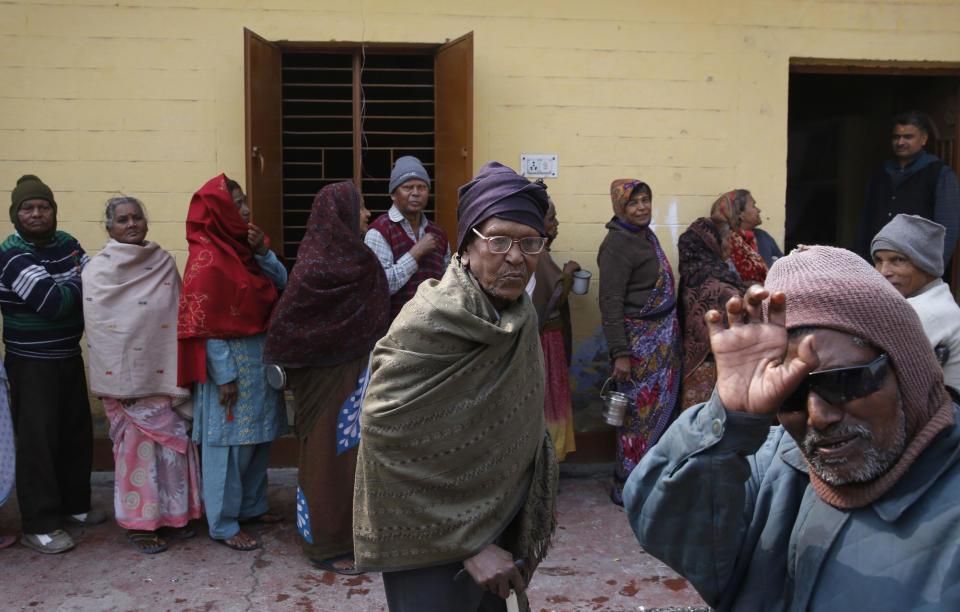 In this Feb. 16, 2014 photo, Indian men and women suffering from leprosy wait in a queue for food at a leper colony in New Delhi, India. The stigma of leprosy endures in India, even though the country has made great strides against the disease, which is neither highly contagious nor fatal. Now the number of new annual cases has risen slightly after years of steady decline, and medical experts say the enormous fear surrounding leprosy is hindering efforts to finally eliminate it. (AP Photo/Manish Swarup)