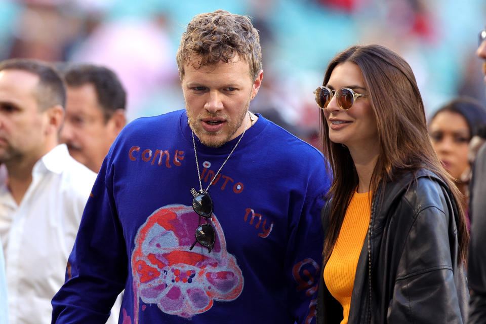 Sebastian Bear-McClard (L) and Emily Ratajkowski look on prior to Super Bowl LIV between the San Francisco 49ers and the Kansas City Chiefs at Hard Rock Stadium on February 02, 2020 in Miami, Florida. (Photo by Rob Carr/Getty Images)