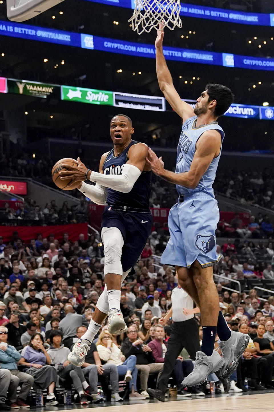 Los Angeles Clippers guard Russell Westbrook, left, shoots against Memphis Grizzlies forward Santi Aldama during the first half of an NBA basketball game, Sunday, Nov. 12, 2023, in Los Angeles. (AP Photo/Ryan Sun)